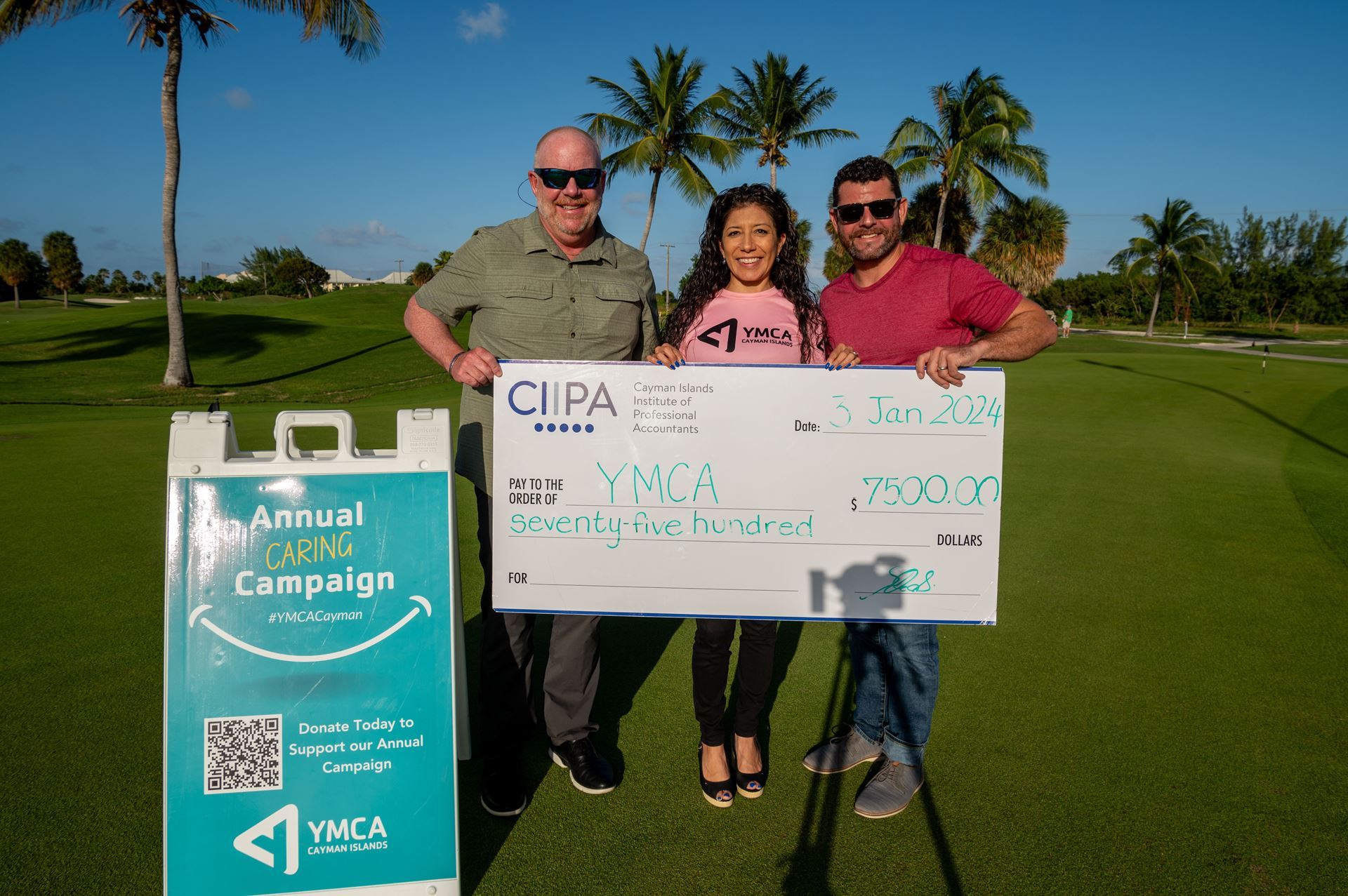 CIIPA's Kevin Morales, right, poses with YMCA's Paola Robinson and Jeff Peterson during a cheque handover photo. 